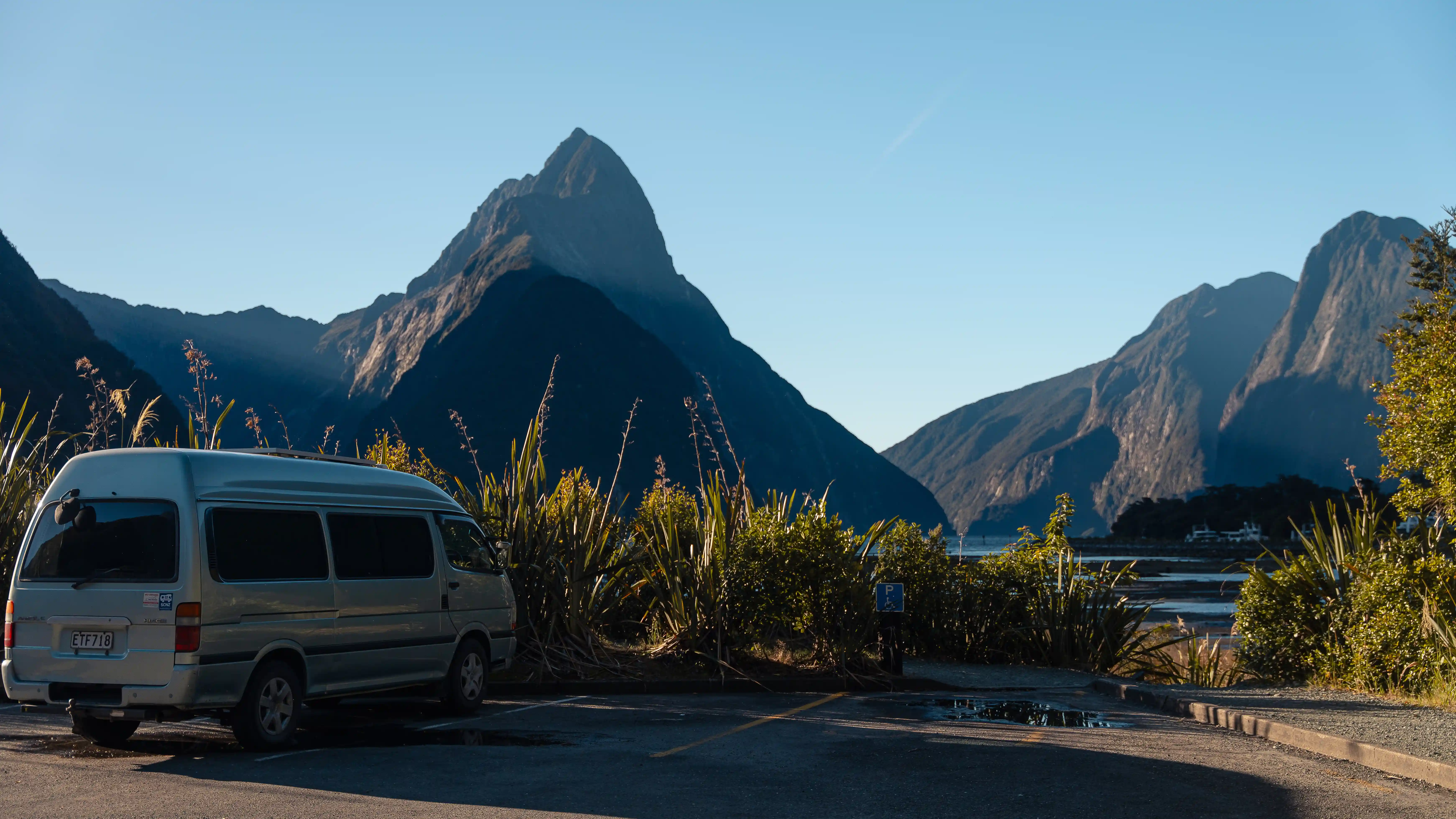 A campervan out in front of Milford Sound New Zealand